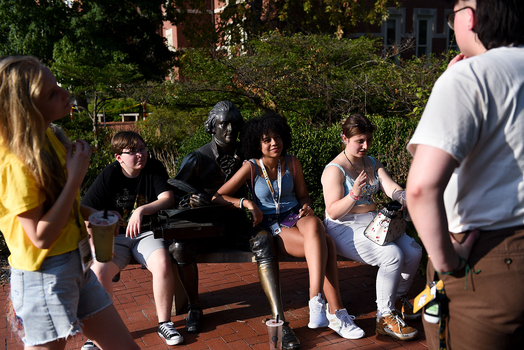 From left, Hannah Brown, Cherikee Morgan, Keria Howard, Sophie Stevens and Lewis Lillard speak in front of the Thomas Jefferson statue